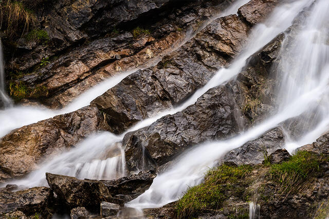 Abstract waterfall detail with diagonal water flow across layered rock, Cascade d'Ardent French Alps France