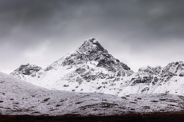 A jagged mountain peak along the Denali Highway in Interior Alaska covered in the season's first snow.