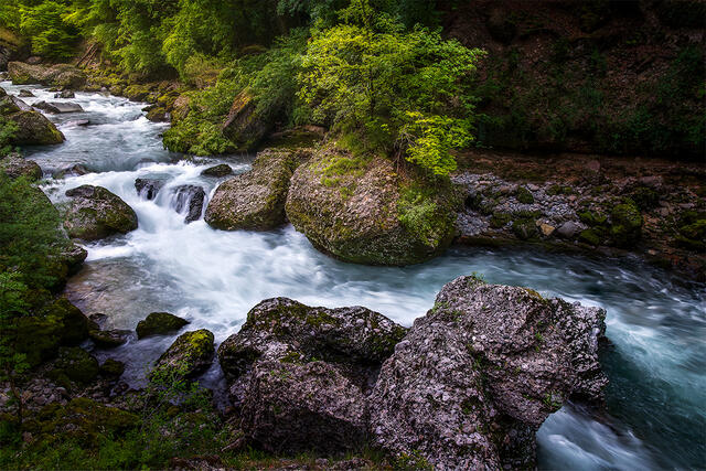 Long exposure cascading rapids with turquoise water and moss-covered rocks, Dranse River French Alps France