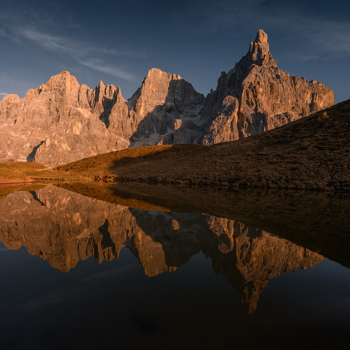 Alpine tarn reflection with Italian Dolomites peaks at sunset near Passo Giau October photography