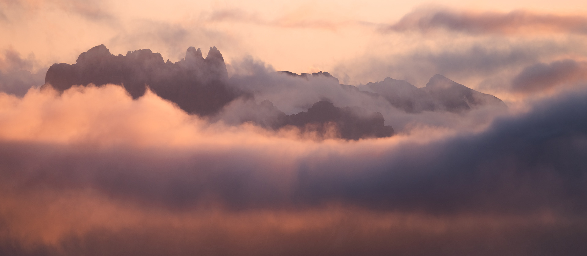 Italian Dolomites peaks floating above fog layers at sunset Passo Giau October landscape photography