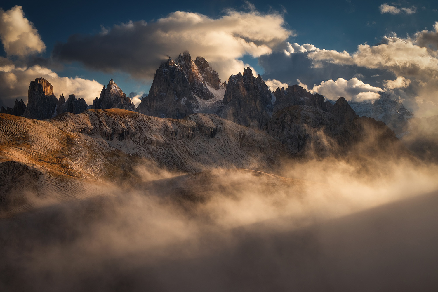 Valley fog inversion at sunrise in Italian Dolomites with peaks emerging from clouds October autumn photography