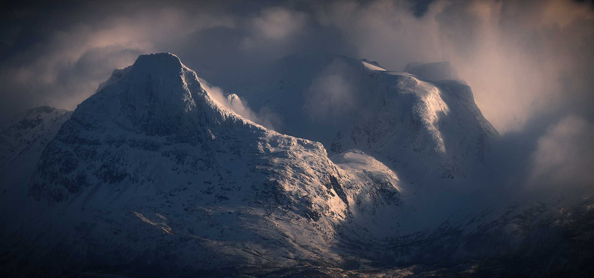 Dramatic clouds and shifting light over Arctic Norway mountain peaks in March