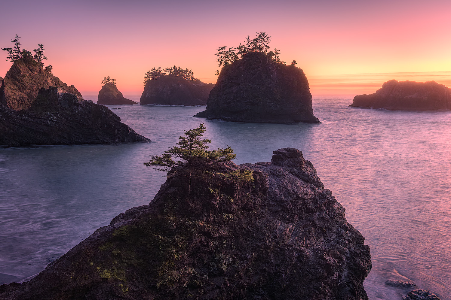 Sea stacks at sunset on the Oregon Coast at Secret Beach captured at ISO 125 with a long exposure on a tripod
