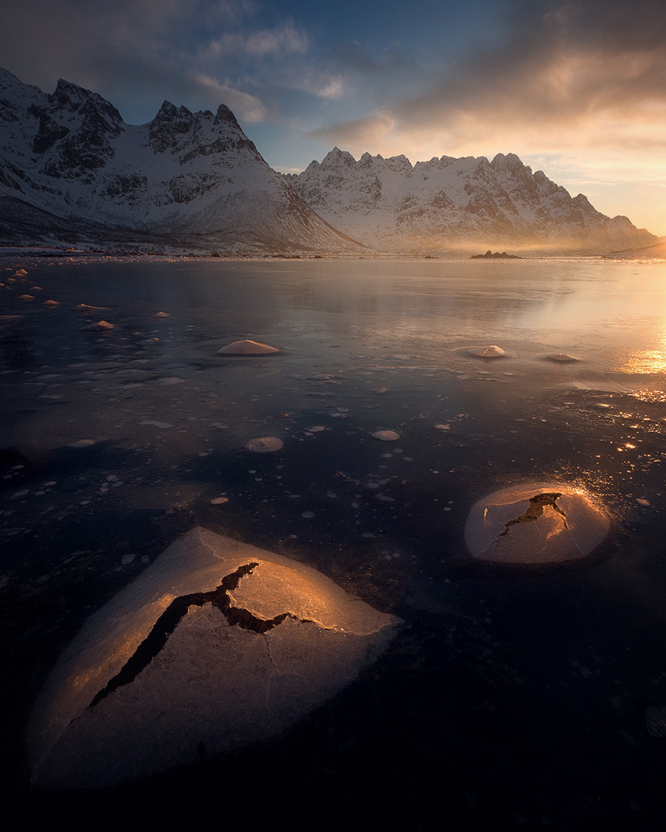 Frozen fjord with ice formations at sunset in Arctic Norway