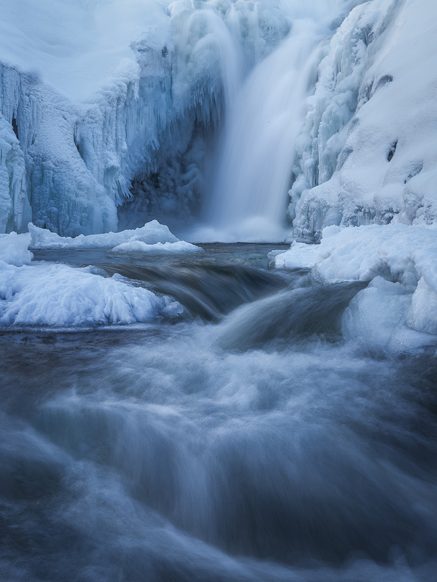 Frozen waterfall with intricate ice formations in Northern Norway