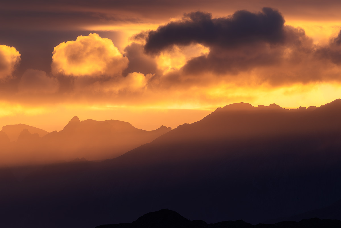 Warm golden hour sunlight illuminating mountain landscape at sunset with long shadows and glowing colors for beginner photography
