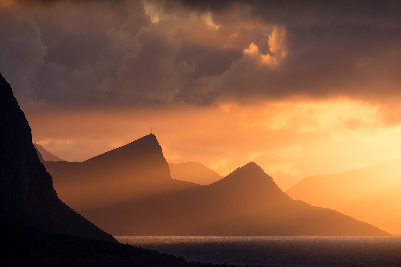 Layered mountain silhouettes at sunset across the Lofoten archipelago in Northern Norway
