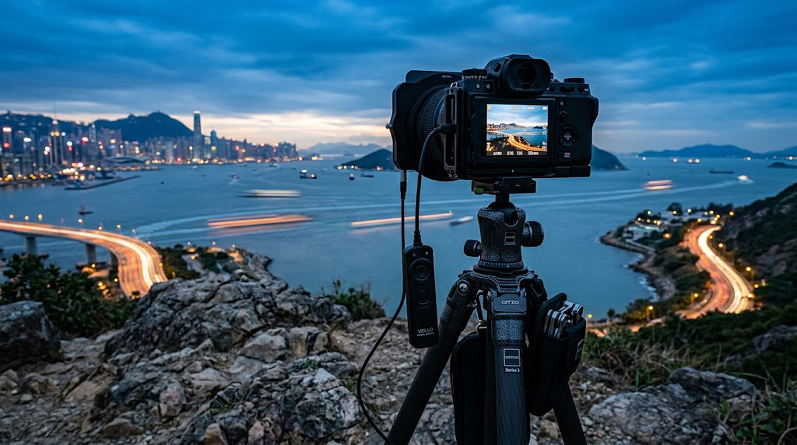 Camera mounted on tripod in the field during golden hour for low ISO landscape photography