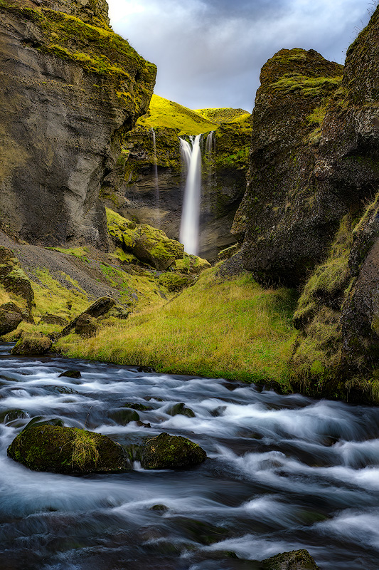 Silky smooth waterfall captured with slow shutter speed on tripod demonstrating long exposure technique for beginner landscape photography
