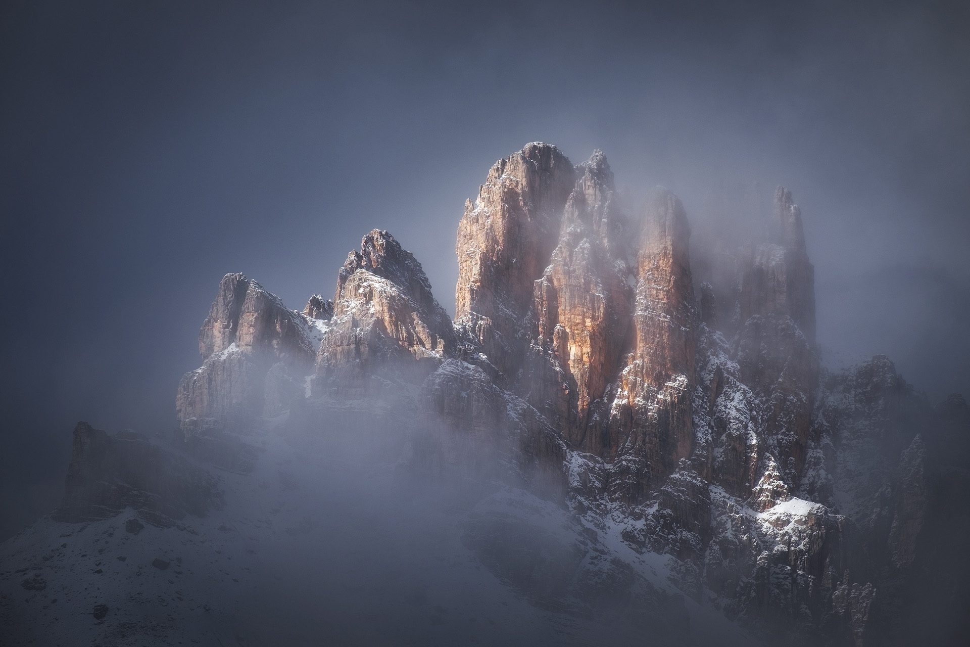 Tre Cime di Lavaredo sunrise with three peaks emerging from clouds Italian Dolomites October photography