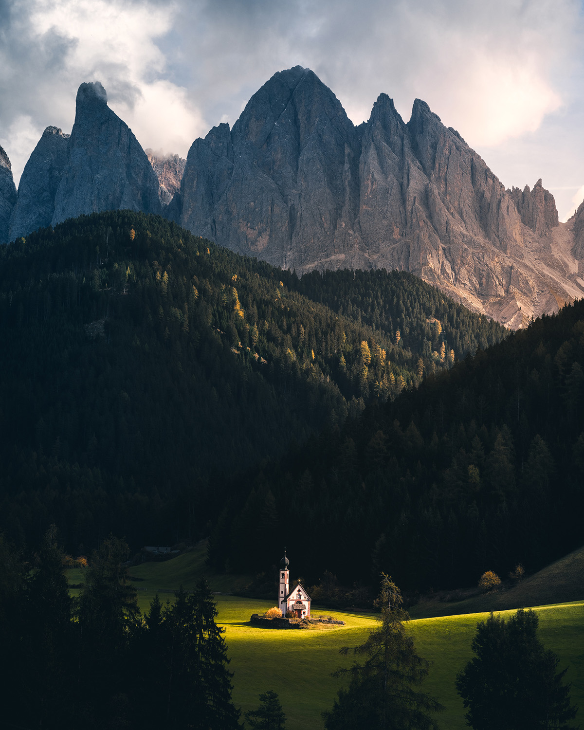 Italian Dolomites October landscape photography — Val di Funes church beneath Odle peaks at golden hour autumn