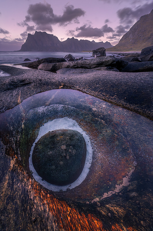 Wide angle landscape photograph with dramatic foreground leading to expansive mountain vista demonstrating immersive composition technique